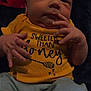 Carter joined the competition — help win amazing prizes! baby, newborn, infant, yellow_shirt, clothing, cute, face, hands, curious, portrait, sitting, blanket, red, black, cozy, soft, cute_expression, indoors, child, toddler