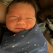 Carter is registered to the contest to win money with this photo: newborn, baby, sleeping, wrapped, blanket, stars, face, peaceful, infant, cute, cozy, soft, closeup, portrait, skin, hair, child, resting, indoors, person