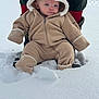baby, child, snow, winter_clothing, snowsuit, hood, blue_eyes, outdoor, cold_weather, adult_support, boots, fence, curious_expression, warm_clothing, snowy_ground, fleece, cute, person, baby_pose, winter