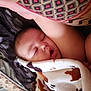 Anna is registered to the contest to win money with this photo: baby, sleeping, blanket, cow_pattern, pillow, bed, cozy, child, peaceful, soft, nap, indoor, resting, cute, infant, comfort, face, head, wrapped, warm