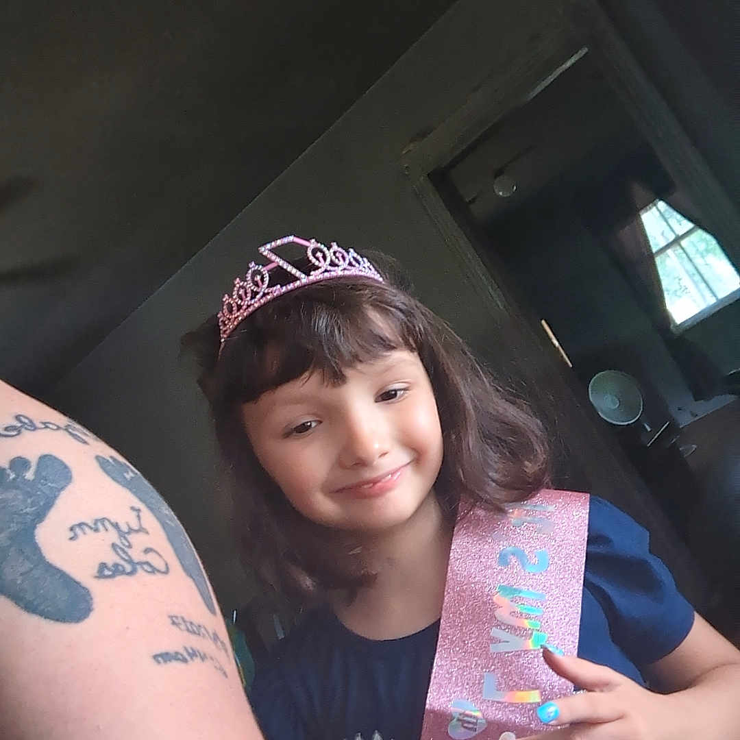 Elizabeth is registered to the contest to win money with this photo: accessories, bodypart, child, crown, face, female, finger, girl, hand, head, jewelry, person, photography, portrait, selfie, skin, tattoo, tiara, turquoise, wrist
