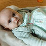 baby, infant, blanket, knit, green_clothing, pastel, face, portrait, indoors, pumpkin, autumn, soft_lighting, closeup, cute, child, young, peaceful, laying_down, warm_colors, cozy