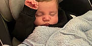 Marceau participe au concours pour gagner de l'argent avec cette photo : baby, sleeping, blanket, car_seat, indoor, child, cozy, soft, cushion, infant, face, hair, hand, clothing, peaceful, toddler, floor, bottle, comfort, quiet