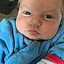Marceau participe au concours pour gagner de l'argent avec cette photo : baby, infant, face, blue_clothing, cute, close_up, chubby_cheeks, eyes, hand, soft_texture, portrait, young_child, indoor, expression, sleeve, fingers, skin, head, person, newborn