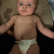 Andrew is registered to the contest to win money with this photo: baby, infant, diaper, couch, blanket, furniture, face, expression, wide_eyes, skin, arm, leg, head, person, indoors, soft, cushion, surprised, child, casual