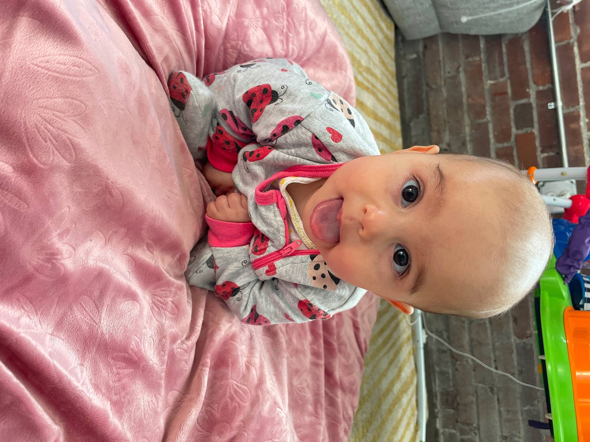 Noelle is registered to the contest to win money with this photo: baby, baby_products, baby_toddler_clothing, cheek, child, comfort, happy, human_body, iris, linens, lip, mouth, nose, person, pink, skin, sleeve, smile, surprise, textile