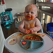Brexton joined the competition — help win amazing prizes! baby, child, cute, eating, face_paint, floor_mat, food, happy, high_chair, indoor, kitchen, meal_time, messy, person, plate, smiling, spaghetti, strawberry, toddler, wood_floor