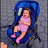 baby, child, stroller, smiling, laughing, outdoor, sidewalk, pavement, blue_stroller, pink_clothing, pink_socks, curly_hair, sitting, infant, portrait, hand, pavement_pattern, park, daylight, happy