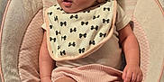 Annilynn is registered to the contest to win money with this photo: baby, infant, bib, baby_seat, clothing, pink_shorts, face, skin, legs, feet, hand, cushion, comfort, indoor, child, cute, young, expression, portrait, small