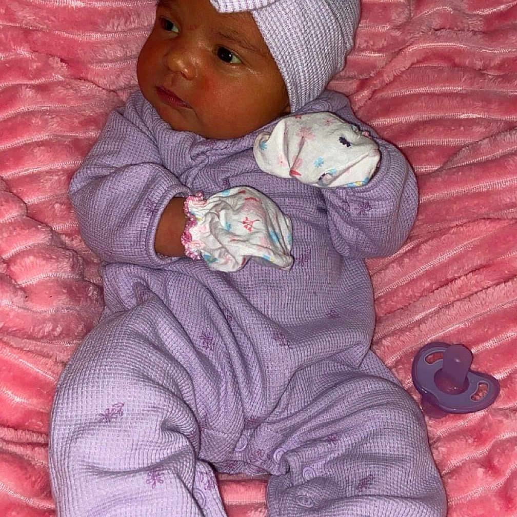 Jaionna joined the competition — help win amazing prizes! baby, bed, blanket, bonnet, cap, clothing, face, furniture, glove, hat, head, newborn, pants, person, photography, portrait, purple, quilt, sleeping, toy