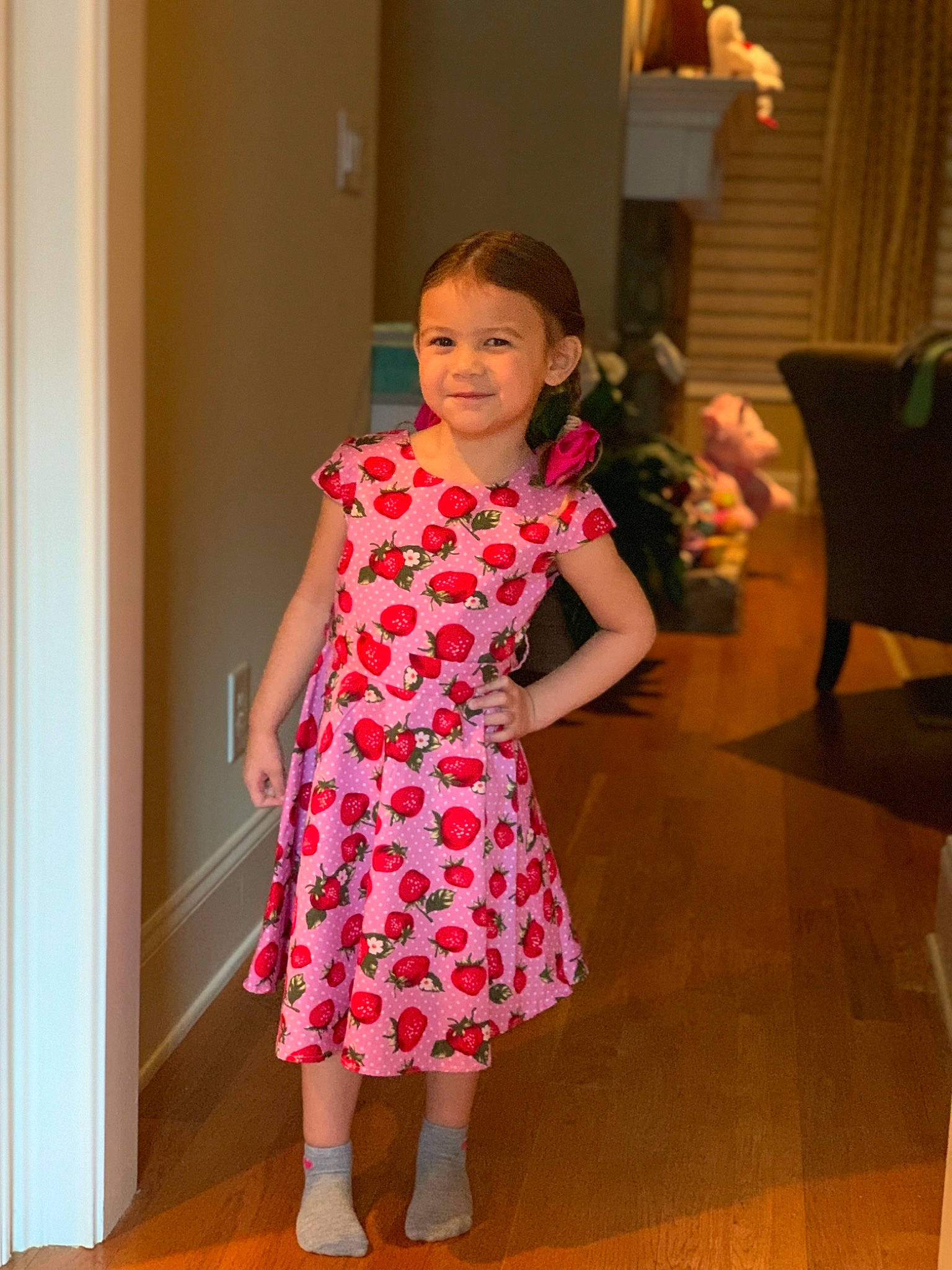 Emily is registered to the contest to win money with this photo: baby_toddler_clothing, chair, day_dress, door, dress, event, fashion_design, flooring, fun, hairstyle, happy, joy, magenta, one_piece_garment, pattern, person, pink, sleeve, smile, standing