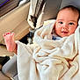 baby, blanket, car_seat, child, infant, smile, foot, cozy, wrapped, cute, happy, indoors, seat, clothing, person, portrait, baby_face, soft, warm, car_interior
