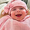 baby, smiling, pink_hat, pink_blanket, bow, infant, happy, face, portrait, cozy, indoors, cute, child, wrapped, headwear, soft_texture, blanket, expression, person, closeup