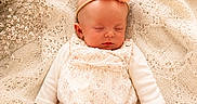 Aurora Elowen is registered to the contest to win money with this photo: baby, infant, sleeping, blanket, knitted_blanket, headband, flower, baby_breath, soft_light, cream_color, tights, onesie, peaceful, cute, newborn, portrait, cozy, delicate, hand, resting