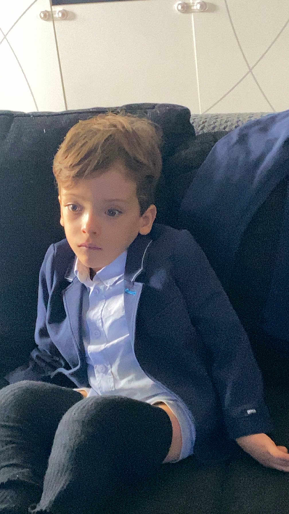 Kassim Menassel participe au concours pour gagner de l'argent avec cette photo : black_pants, blazer, boy, casual, child, couch, expression, face, furniture, hair, home, indoor, person, portrait, relaxed, seated, sitting, thoughtful, white_shirt, young