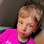 blond_hair, boy, casual_clothing, child, childhood, cute, expression, eyes, face, human, indoor, looking_at_camera, person, pink_shirt, portrait, short_hair, sitting, skin, tshirt, young