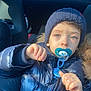Isaak participe au concours pour gagner de l'argent avec cette photo : baby, blue_sky, car_interior, child, childhood, cute, expression, eyes, face, hand, knit_hat, pacifier, portrait, puffer_jacket, seat, sunlight, warm_clothing, window, winter, winter_clothing
