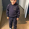 boy, casual_clothing, child, cute, fashion, footwear, full_body, hallway, happy, hoodie, indoor, light, person, portrait, smiling, sneakers, standing, sweatpants, wooden_floor, young