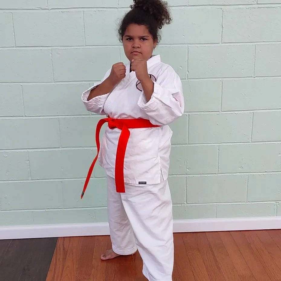 Jazzlyn is registered to the contest to win money with this photo: arm, belt, blazer, collar, dress_shirt, elbow, flooring, gesture, hardwood, knee, leg, martial_arts_uniform, outerwear, person, sleeve, sportswear, thigh, thumb, uniform, waist
