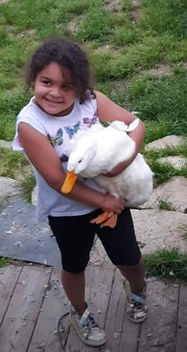 Jazzlyn is registered to the contest to win money with this photo: child, companion_dog, fawn, fur, grass, happy, joy, natural_material, person, sandal, shorts, smile, thumb, toddler, toy