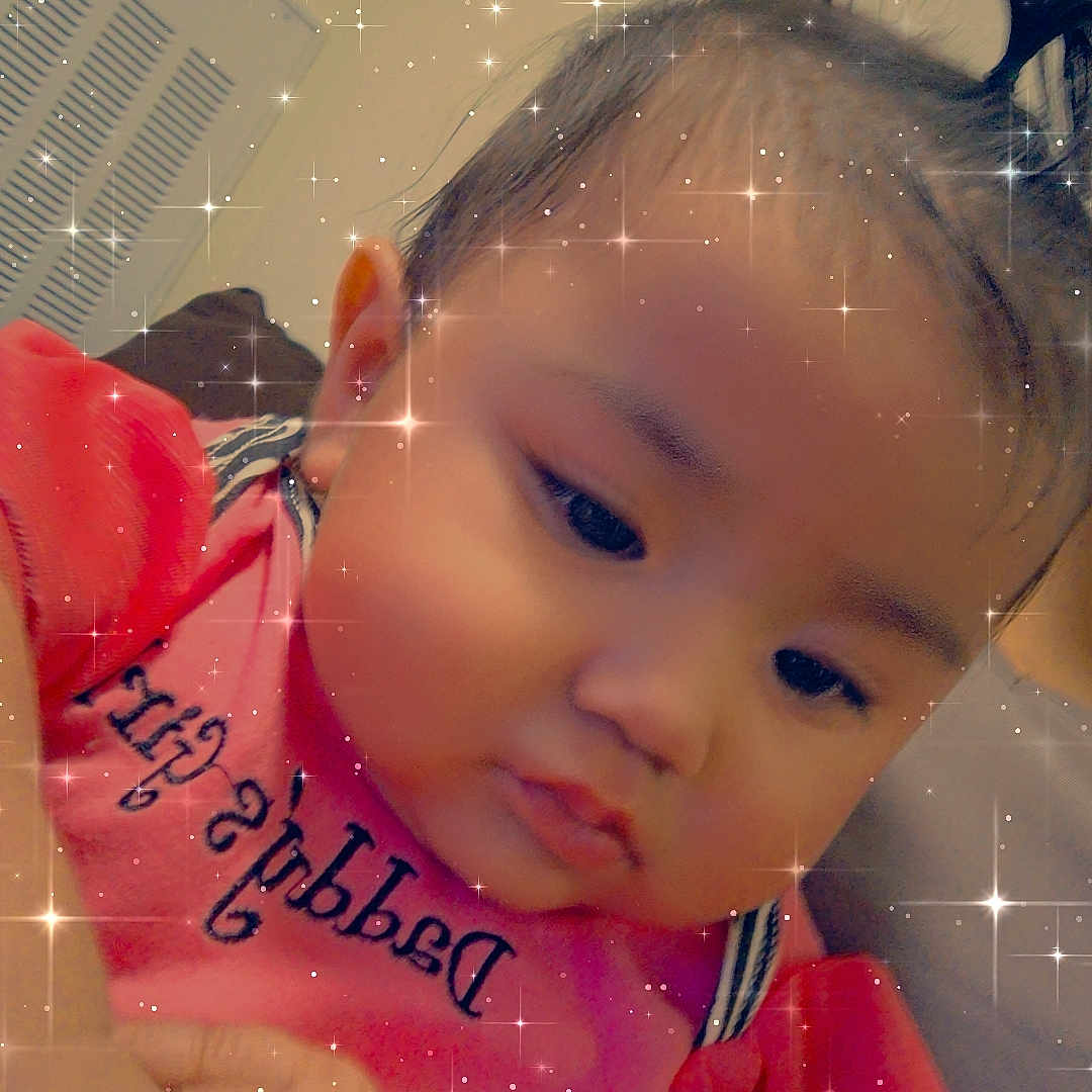 Aleia is registered to the contest to win money with this photo: baby, casual, child, closeup, cute, expression, face, hair, hand, indoors, lighting, magical_effect, person, pink_clothing, portrait, sitting, skin, soft_focus, sparkles, young_child