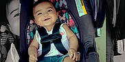 Aleia is registered to the contest to win money with this photo: baby, car_seat, child, smiling, infant, safety_harness, cute, colorful, patterned, clothing, socks, bow, portrait, indoor, happy, seat_belt, person, seat, closeup, baby_girl
