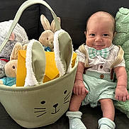 Thor joined the competition — help win amazing prizes! baby, bow_tie, bunny_basket, child, couch, cozy, cute, fabric, happy, indoors, infant, mint_green, person, pillow, plush_toys, seated, shorts, smile, socks, soft_toys