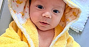 Thor is registered to the contest to win money with this photo: baby, baby_bathrobe, blanket, child, cozy, cute, duck_design, expression, eyes, face, hand, hooded_towel, indoors, infant, person, portrait, skin, soft_texture, warm_clothing, yellow_bathrobe