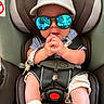 Thor is registered to the contest to win money with this photo: accessories, baby, baby_clothes, car_seat, casual, child, clothing, cute, footwear, hands, hat, indoor, infant, person, portrait, reflection, safety, seat, straps, sunglasses