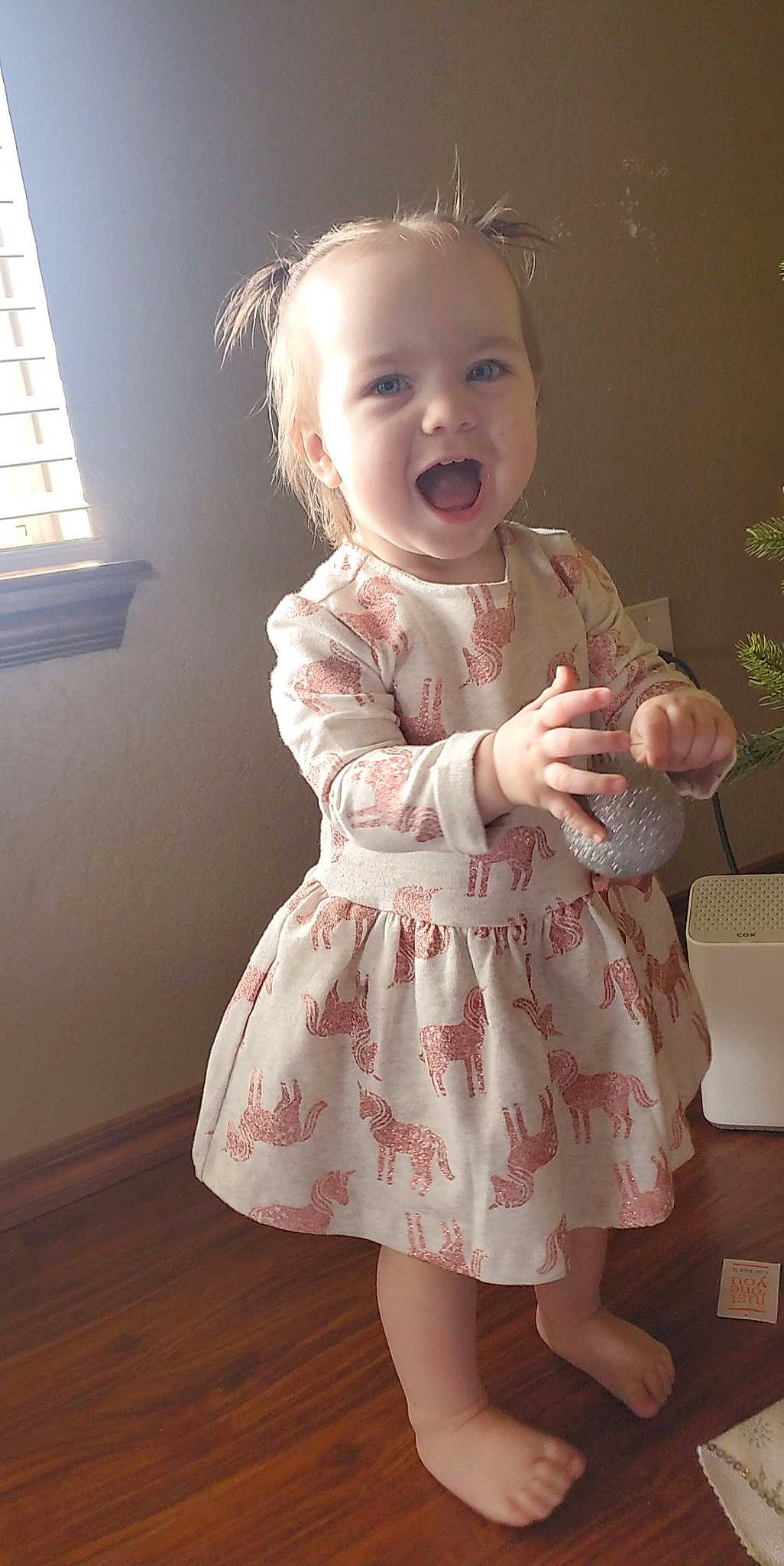 Isabella is registered to the contest to win money with this photo: baby, baby_toddler_clothing, blond, cheek, child, day_dress, facial_expression, finger, happy, iris, joint, one_piece_garment, person, pink, shoulder, skin, sleeve, smile, standing, toddler