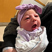 Kaylee is registered to the contest to win money with this photo: baby, newborn, infant, blanket, headband, bow, wrapped, person, indoor, holding, clothing, cute, soft, closeup, face, expression, child, human, portrait, newborn_baby