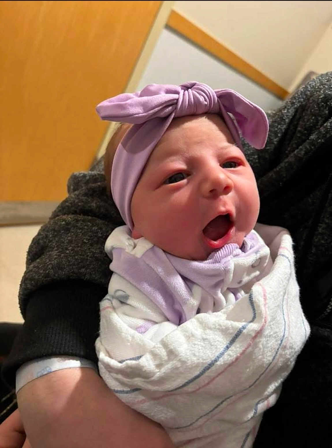 Kaylee is registered to the contest to win money with this photo: baby, newborn, infant, blanket, headband, bow, wrapped, person, indoor, holding, clothing, cute, soft, closeup, face, expression, child, human, portrait, newborn_baby