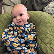Rowan joined the competition — help win amazing prizes! baby, child, onesie, clothing, smile, face, cushion, quilted, green, comfort, cute, pattern, food_illustration, infant, happy, indoors, portrait, relaxed, seated, cozy