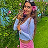 Apollo is registered to the contest to win money with this photo: woman, cat, tabby_cat, pet, portrait, outdoor, garden, flowers, hibiscus, greenery, grass, blue_wall, sunglasses, smiling, long_hair, white_top, pink_skirt, holding_pet, nature, photography
