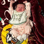 Eriyah joined the competition — help win amazing prizes! baby, infant, sleeping, pink_clothing, bib, blanket, cartoon, dog, face, hands, feet, cute, lying_down, stretching, cozy, soft_texture, home, child, newborn, expression