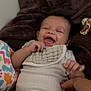 Eriyah is registered to the contest to win money with this photo: baby, smiling, infant, blanket, onesie, bib, hand, adult, plush_toy, giraffe, pillow, dinosaur_pattern, video_call, woman, happy, indoor, person, face, portrait, candid