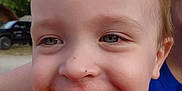 Wesley is registered to the contest to win money with this photo: toddler, child, smiling, face, messy_face, outdoor, daylight, person, happy, closeup, skin, hair, eyes, teeth, clothing, yellow, blue, background, nature, vehicle