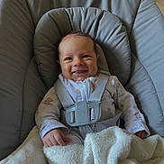 George joined the competition — help win amazing prizes! baby, infant, smile, dimples, blanket, seat, straps, clothing, onesie, cushion, indoor, happy, child, cute, face, person, comfort, rest, baby_boy, cozy
