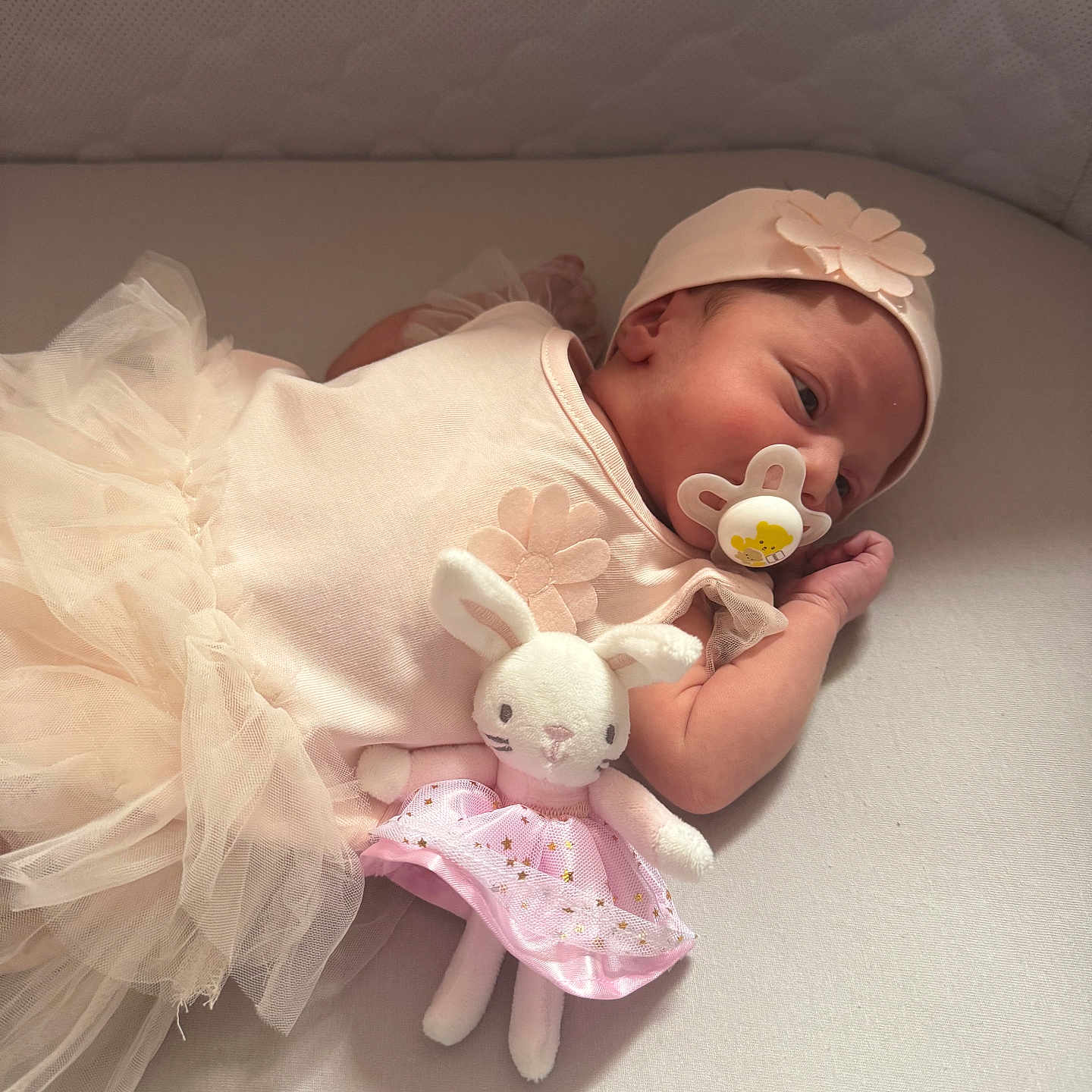 Sophia joined the competition — help win amazing prizes! baby, bed, bunny, child, clothing, cute, flower, hat, indoors, infant, mattress, newborn, pacifier, peaceful, pink_skirt, plush_toy, resting, sleeping, soft_toys, tulle_skirt