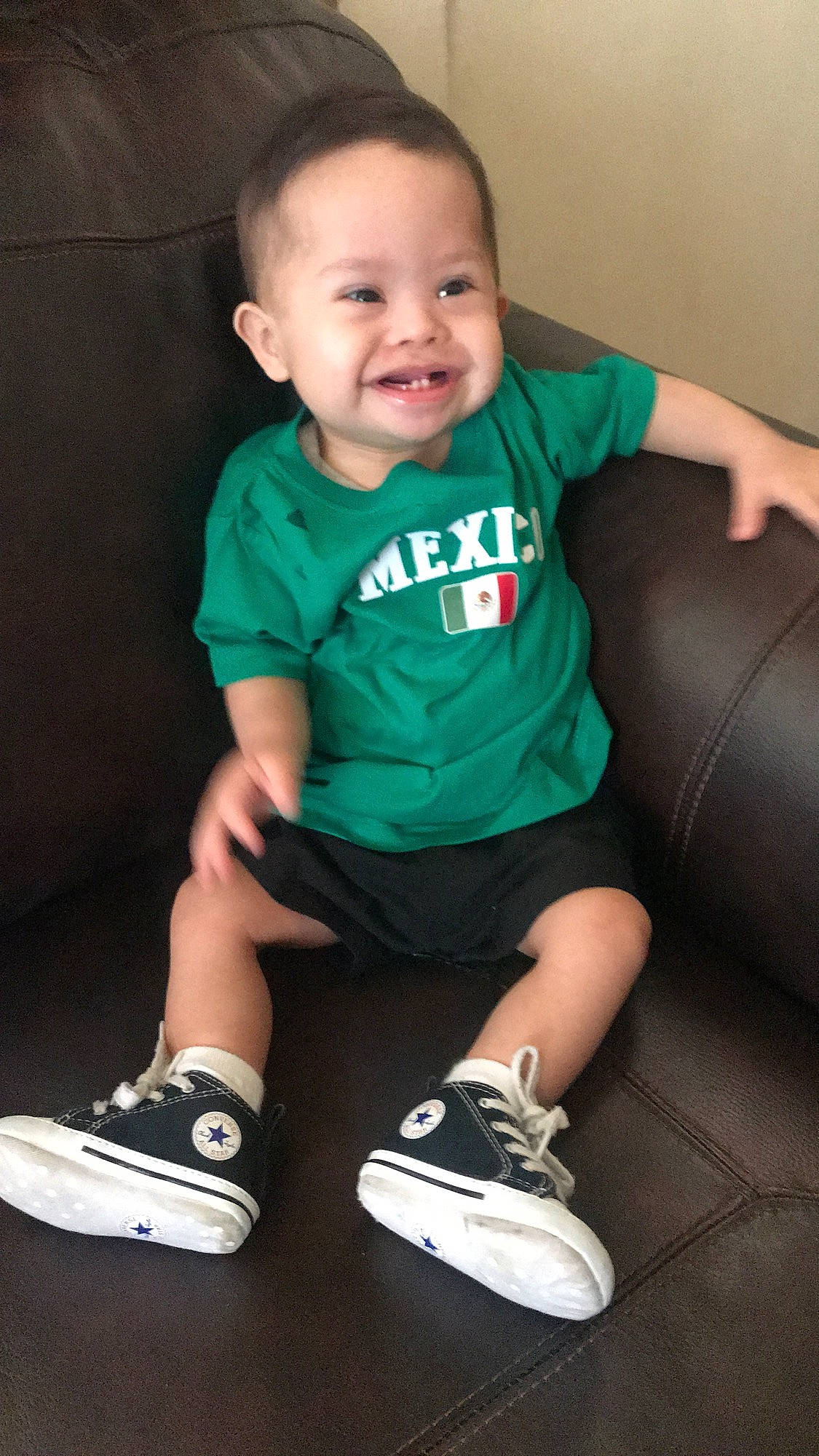 Erick joined the competition — help win amazing prizes! arm, baby, cheek, child, cool, footwear, green, human_leg, joy, knee, leg, person, shoe, sitting, skin, smile, sneakers, t_shirt, toddler