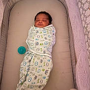 Kamarion Gaskill joined the competition — help win amazing prizes! newborn, baby, swaddled, sleeping, bassinet, blanket, pacifier, infant, cute, cozy, pattern, animal_print, resting, child, bed, soft, quiet, peaceful, indoors, nursery