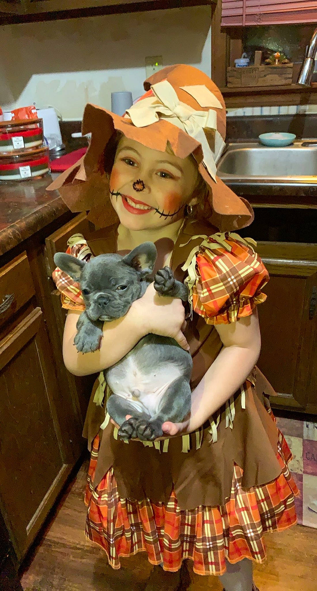 Bentlee is registered to the contest to win money with this photo: arm, baseball_cap, cabinetry, cap, child, cooking, drawer, event, fawn, hat, home_appliance, kitchen, kitchen_appliance, microwave_oven, pattern, smile, stuffed_toy, table, textile, toy