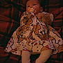 Millie is registered to the contest to win money with this photo: baby, infant, pacifier, dress, patterned_clothing, blanket, red, white, festive, holiday, reindeer, snowman, cute, lying_down, indoors, warm, child, newborn, soft, comfort