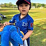 Elias is registered to the contest to win money with this photo: child, boy, blue_jersey, baseball_cap, plush_toy, outdoor, grass, daylight, sportswear, toy, person, field, casual, cap, holding, young, portrait, cute, childhood, playful