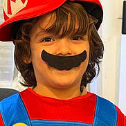 Amir a rejoint le concours — aidez-le/la à gagner de superbes lots ! child, costume, mario, hat, mustache, red, blue, yellow, face, smile, indoor, hair, childhood, playful, portrait, fun, dressup, person, cute, happy