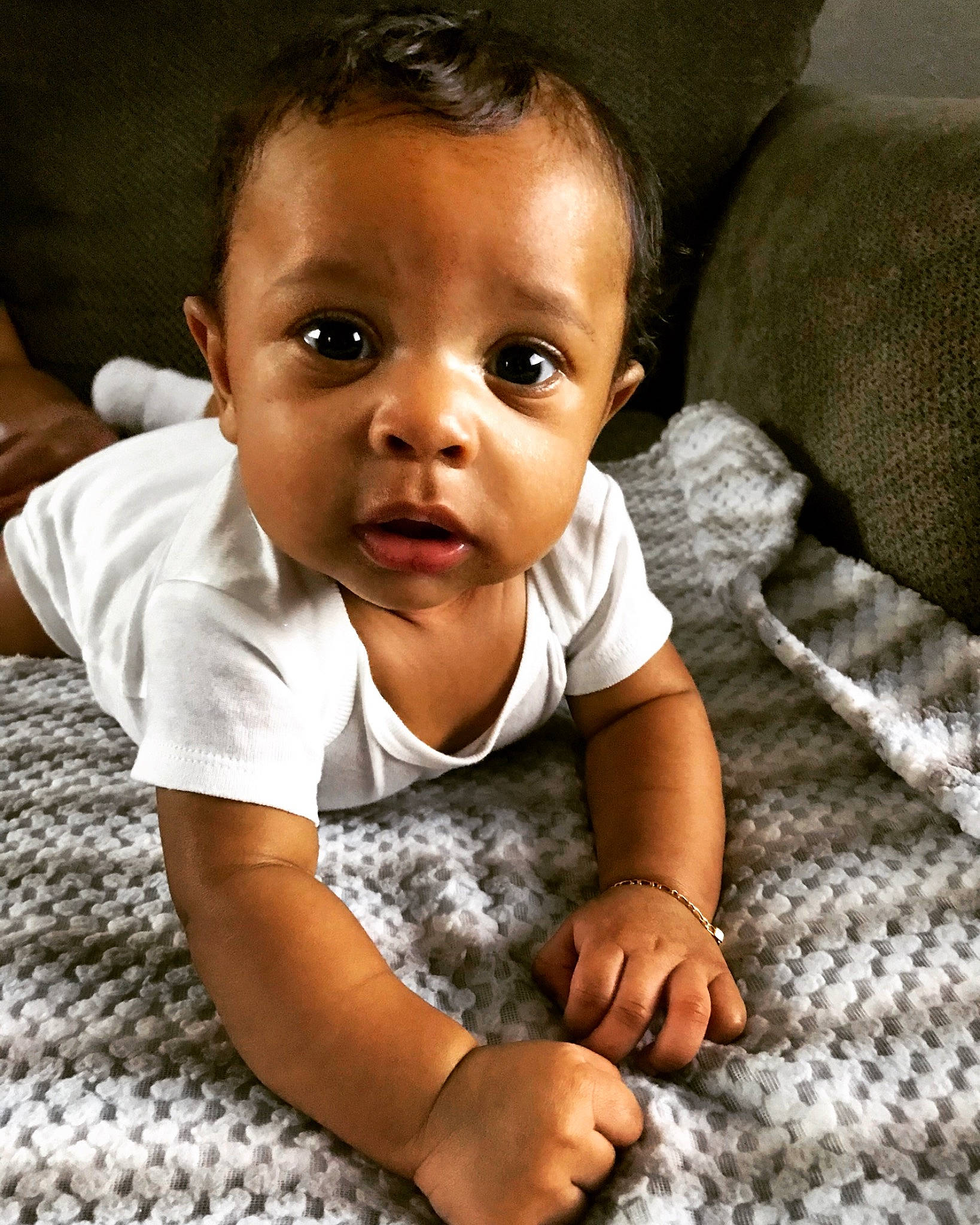 Khamari is registered to the contest to win money with this photo: baby, baby_toddler_clothing, cheek, child, chin, comfort, crawling, flash_photography, flooring, fun, happy, head, iris, nose, pattern, person, sitting, sleeve, smile, toddler