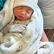 Umayan is registered to the contest to win money with this photo: architecture, baby, bed, blanket, bonnet, building, clothing, face, furniture, glove, hat, head, hospital, newborn, person, photography, portrait, quilt, sleeping, towel
