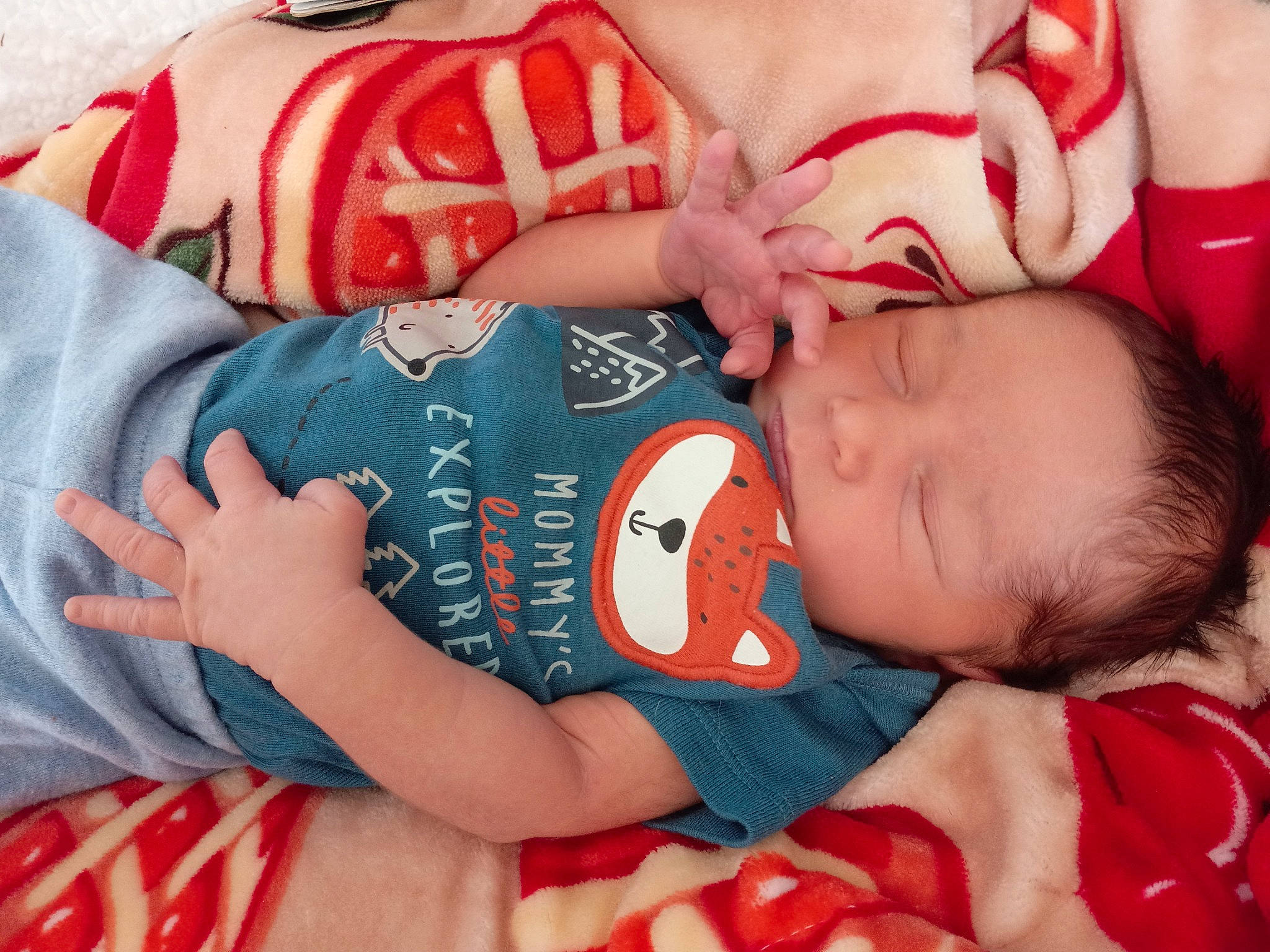 Silas is registered to the contest to win money with this photo: arm, baby, baby_toddler_clothing, cheek, comfort, eye, finger, hand, human_body, mammal, mouth, muscle, orange, organ, person, product, red, skin, sleeve, textile