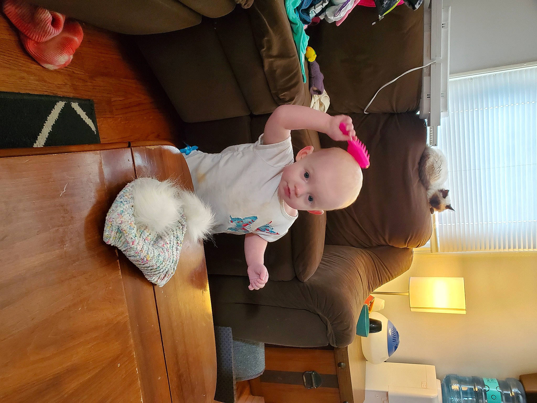 Amira is registered to the contest to win money with this photo: baby, baby_products, baby_toddler_clothing, baby_toys, child, eyewear, finger, flooring, fun, hardwood, human_body, leg, person, pink, play, room, sitting, thigh, toddler, toy
