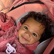 Azurii joined the competition — help win amazing prizes! baby, child, closeup, comfort, cozy, curly_hair, cute, face, happy, indoor, infant, pacifier, person, pink_jacket, portrait, smile, soft_texture, stroller, warm_clothing, young_child